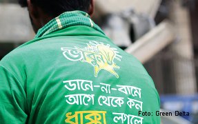 A rickshaw puller wears one of the shirts issued by Green Delta.